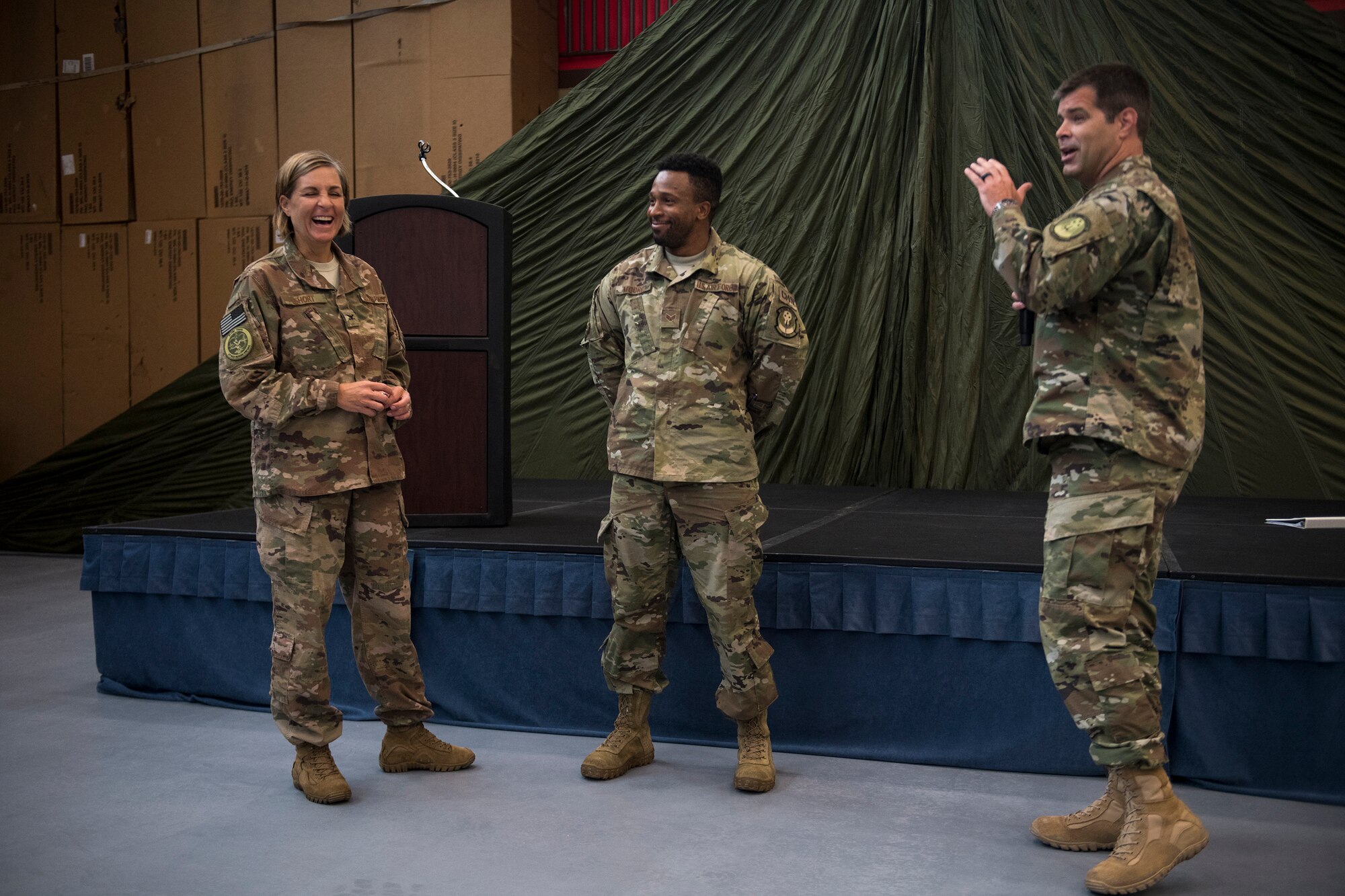 Lt. Col. Derek Cunningham, right, 563d Operations Support Squadron commander, Senior Airman Nicholas Moore, center, 563d OSS support staff, and Col. Jennifer Short, share a moment during Short’s last commander’s call to the 563d Rescue Group, Sept. 27, 2018, at Davis-Monthan Air Force Base, Nev. Effective 1 Oct., the 563d RQG and its associated maintenance squadrons will be realigned from the 23d WG to the 355th Fighter Wing. (U.S. Air Force photo by Staff Sgt. Ryan Callaghan)