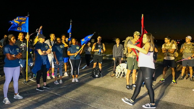 Staff Sgt. Ashley Hookey, 412th Operations Support Squadron, welcomes participants to the Fight for Life Suicide Prevention and Awareness Event at Edwards Air Force Base, California, Sept. 28-29. The event was an overnight relay ruck march, run or walk. (U.S. Air Force photo by Giancarlo Casem)