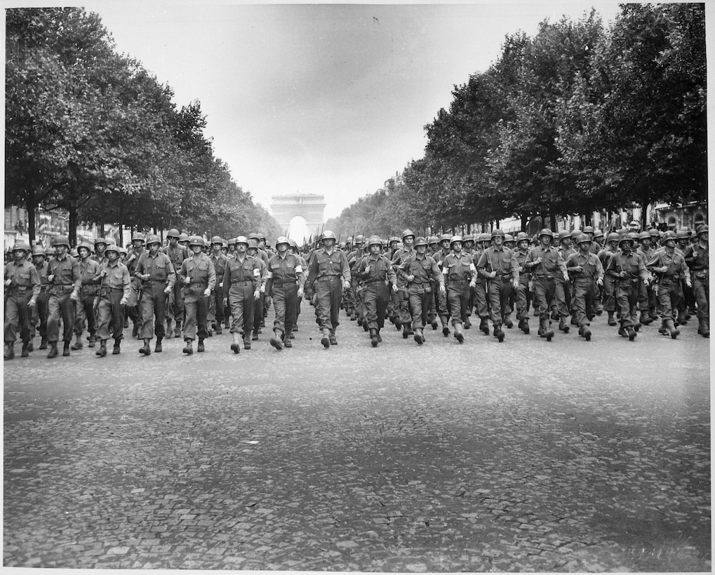 Soldiers march down the Champs Elysees.