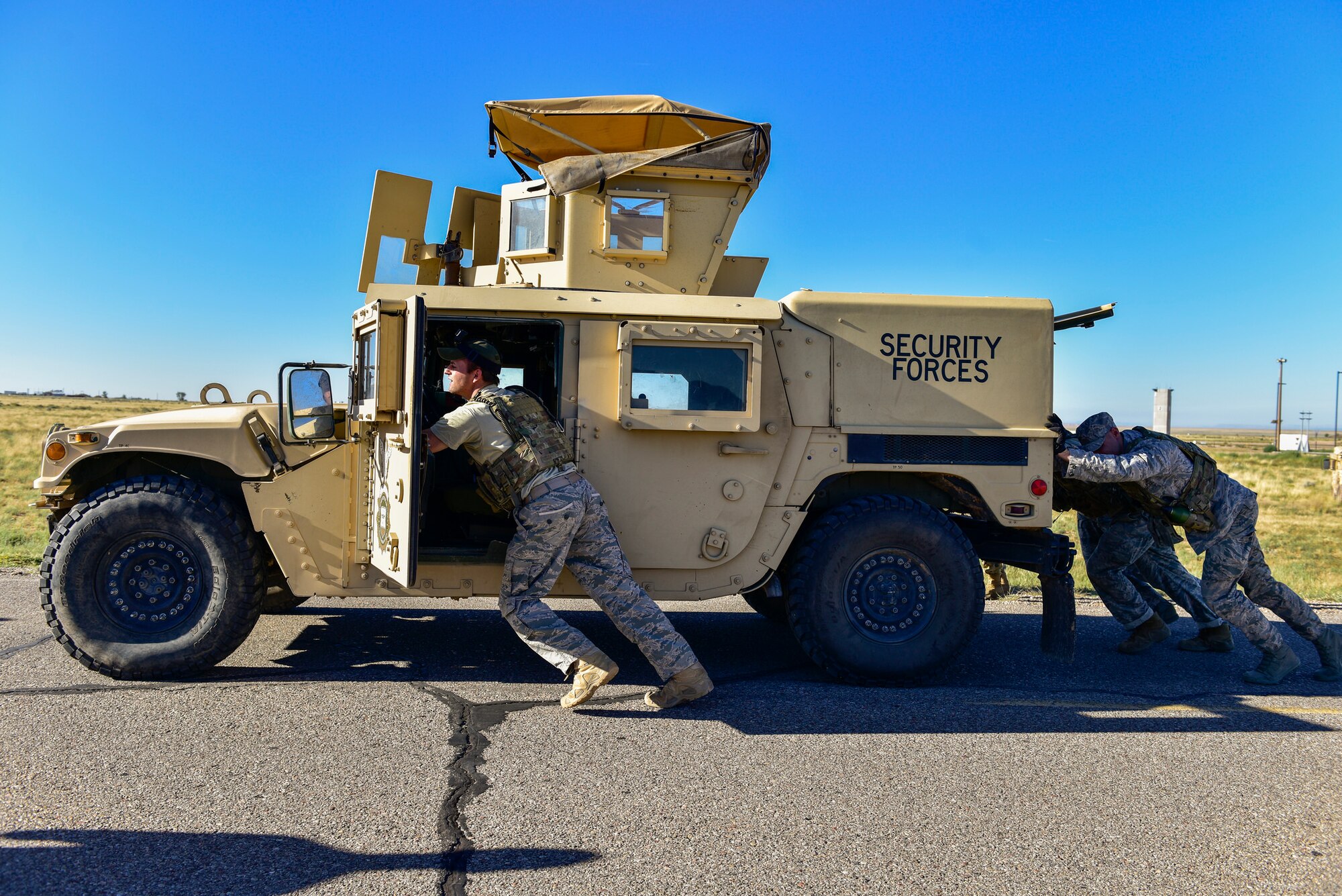 Members of the 377th Weapons Systems Security Squadron's Charlie Flight team push a Humvee as part of the 377th SFG Manzano Challenge here Sept. 28, 2018. The Charlie Flight team finished the 125-meter Humvee push with a time of 4:08. (U.S. Air Force photo by Airman Austin J. Prisbrey)