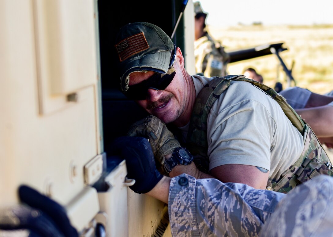 Staff Sgt. Brandon McGaha, 377th Weapons Systems Security Squadron Charlie Flight team member, pushes a Humvee as part of the 377th SFG Manzano Challenge here Sept. 28, 2018. The Charlie Flight team were the overall winners of the Manzano Challenge. (U.S. Air Force photo by Airman Austin J. Prisbrey)