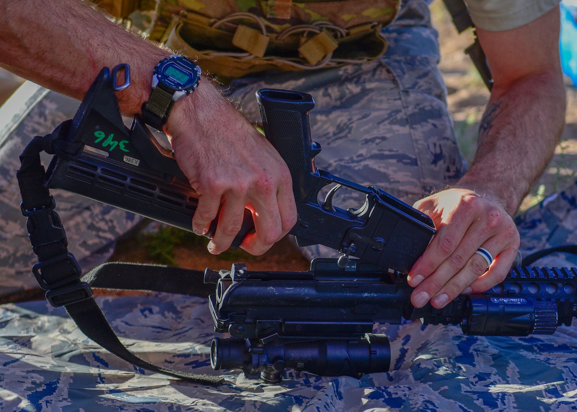 Senior Airman Christian Bertram, 377th Weapons Systems Security Squadron Charlie Flight team member, reassembles an M4 carbine as part of the 377th SFG Manzano Challenge here Sept. 28, 2018. The Manzano Challenge consisted of nine different stations designed to test and build upon Defenders' combat skills. (U.S. Air Force photo by Airman Austin J. Prisbrey)