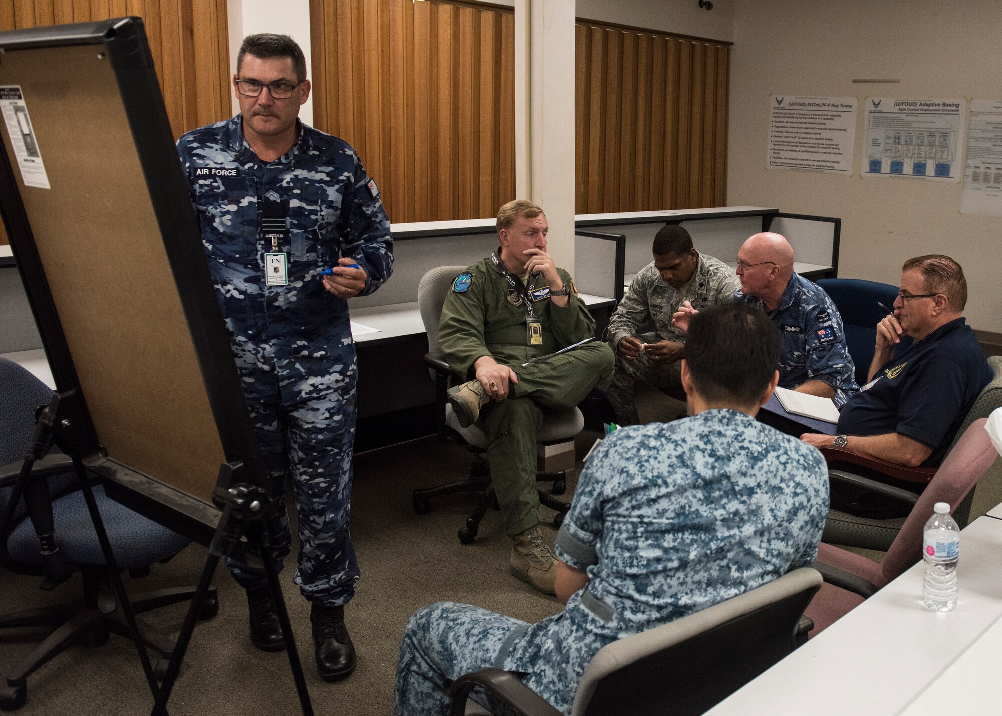 Wing Commander Paul Murray, Royal Australian Air Force 95 Wing executive officer, writes down talking points during a breakout session at the Adaptive Basing and Agile Combat Employment Summit, Joint Base Pearl Harbor-Hickam, Sept. 10, 2018.