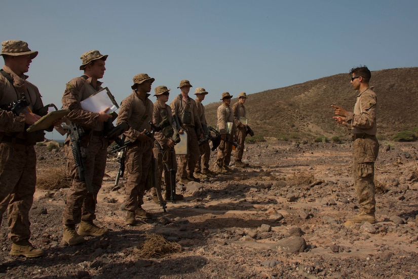 Corporal Logan Stutte briefs his team before a mission.