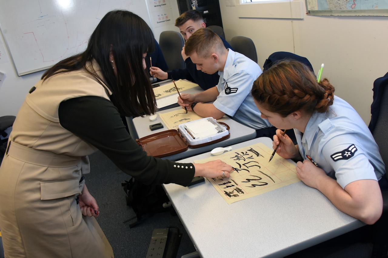 Students practice writing calligraphy.