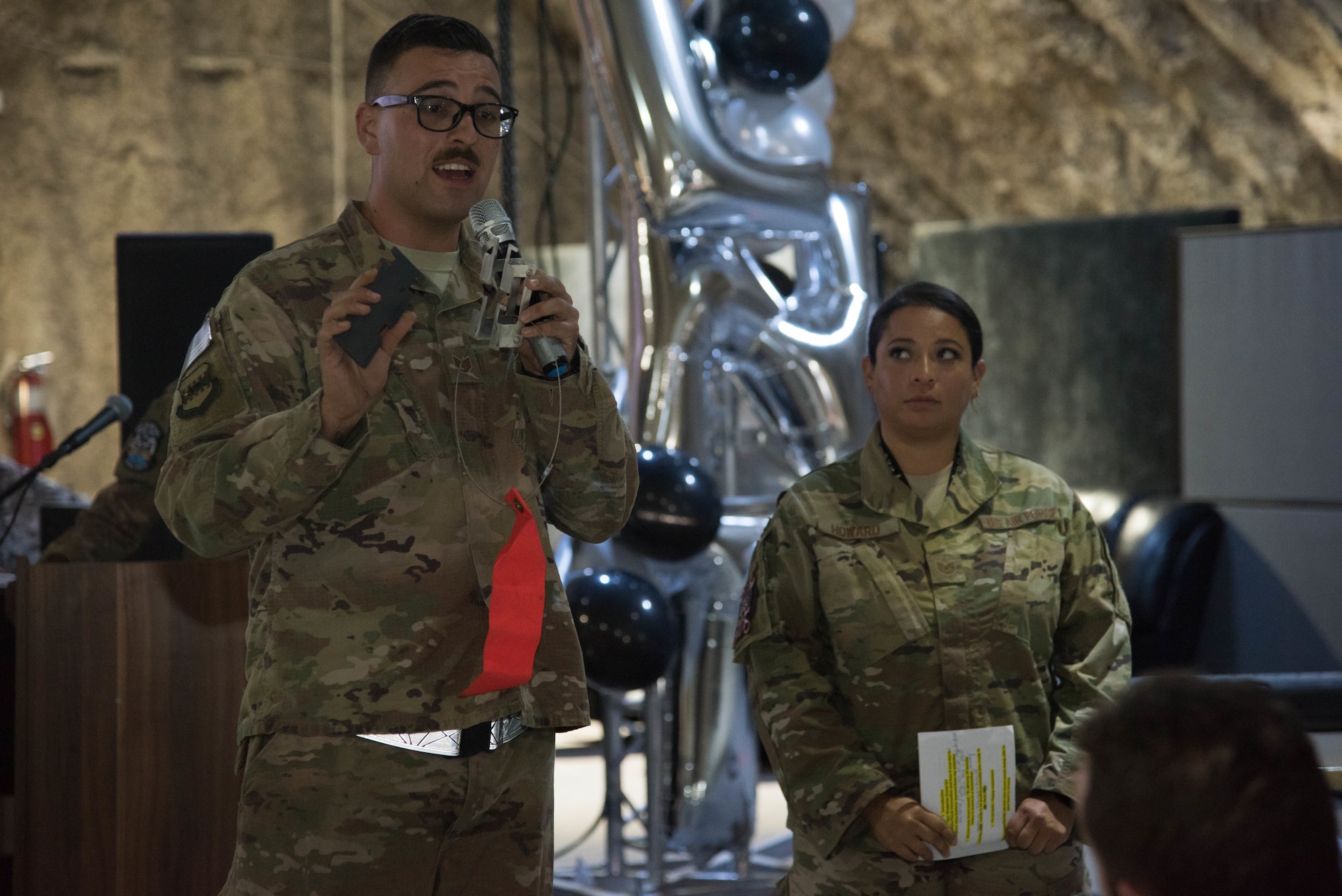 Tech. Sgt. Oralia Howard, 332nd Expeditionary Maintenance Group quality assurance chief inspector, and Staff Sgt. Nathan Newton, 332nd Expeditionary Maintenance Squadron aircraft structural maintenance technician, answer questions for the judges during the first Red Tails Commander’s Innovation Challenge, Sept. 28, 2018, at an undisclosed location in Southwest Asia.