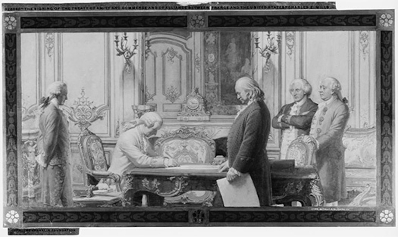 A group of French and American officials sign a treaty.