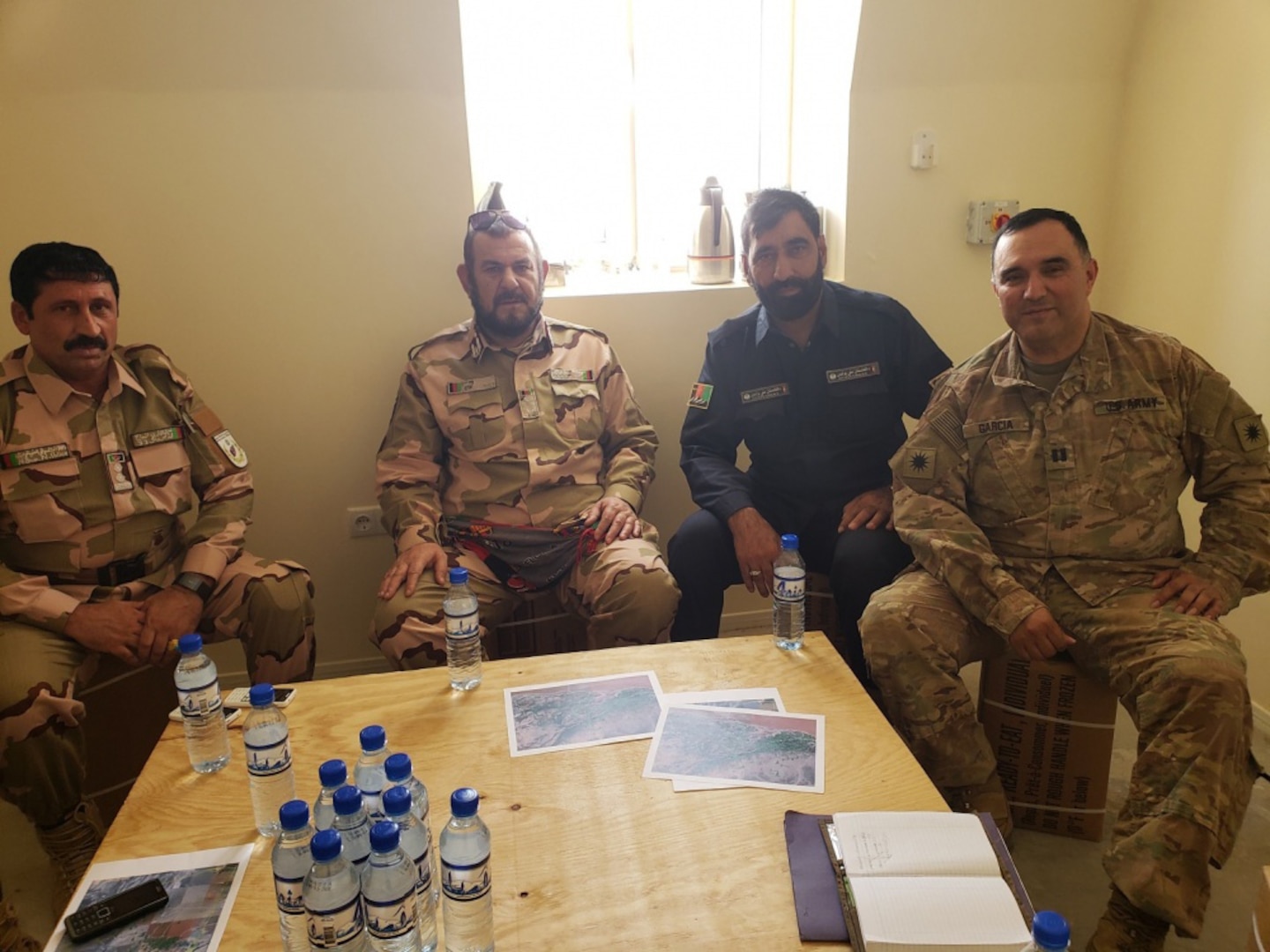 U.S. Army Capt. Vicente Garcia, far right, poses for a group photo with three district chiefs of police during an expeditionary advisory package at Zharay Province in Afghanistan, held on Aug. 8, 2018.