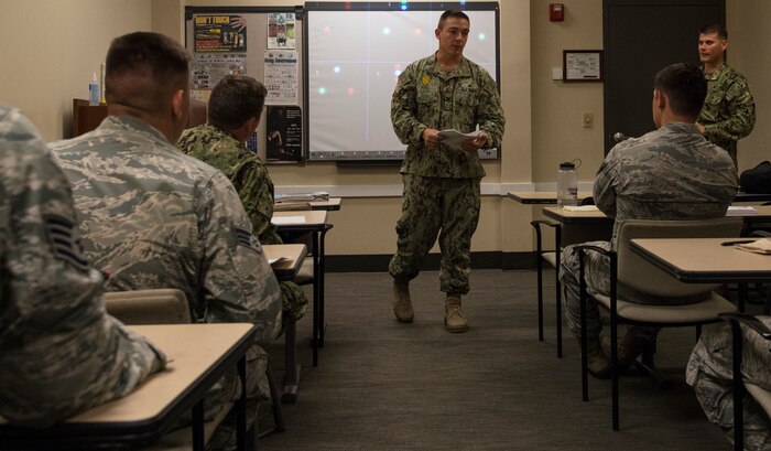 U.S. Navy Master-at-Arms 1st Class Johnathon Post, 628th Security Forces Squadron Shore Installation Management Basic Boat Coxswain Course instructor, teaches a SIMBBC class Sept. 26, 2018, at Joint Base Charleston-Weapons Station, S.C. The SIMBBCC curriculum arms security forces members with skills needed to conduct harbor patrol missions and covers techniques including man overboard drills, pier approaches, towing and anchoring.