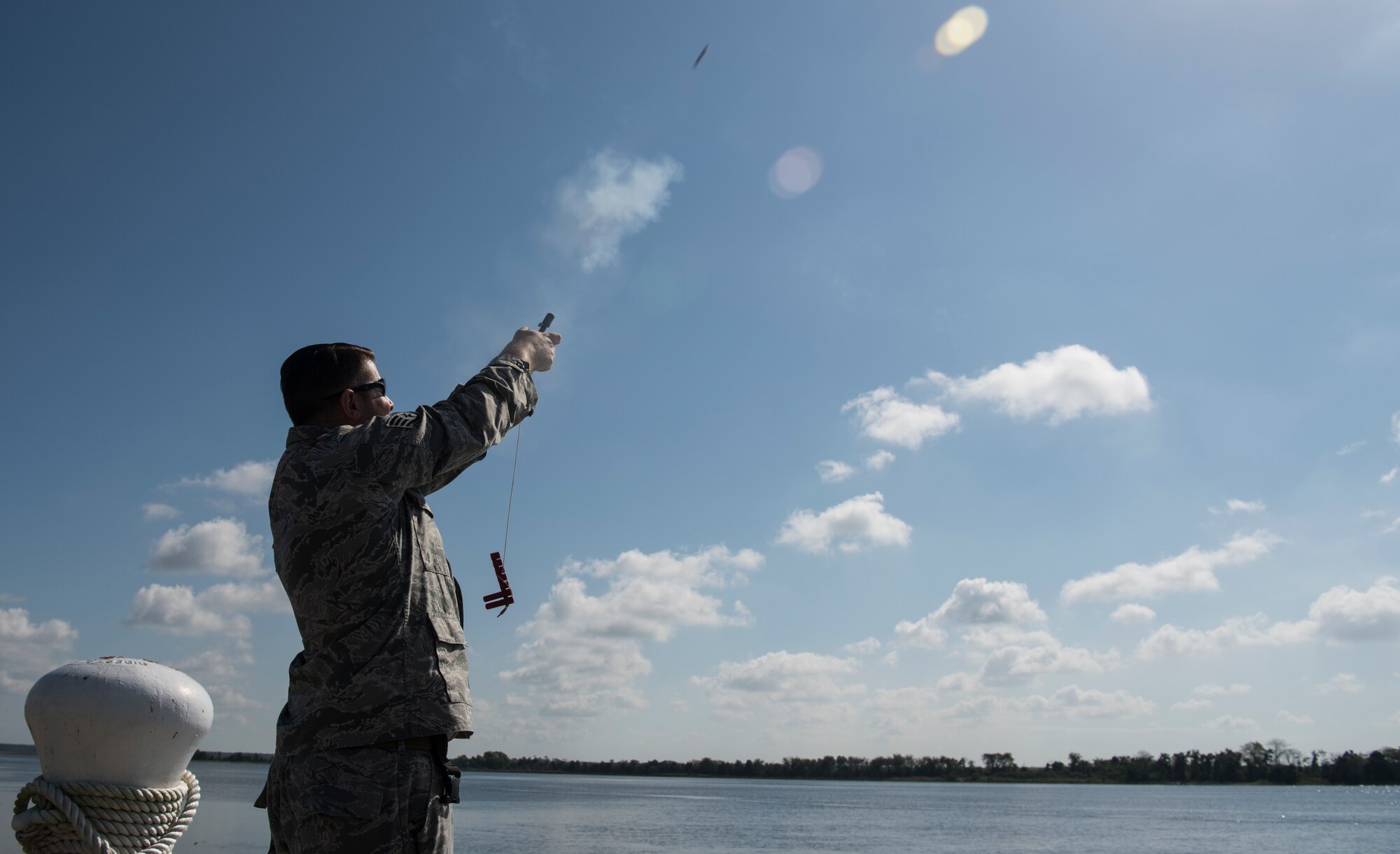 U.S. Air Force Staff Sgt. Curtis March, 628th Security Forces Squadron patrolman, shoots off a pencil flare during a Shore Installation Management Basic Boat Coxswain Course Sept. 26, 2018, at Joint Base Charleston’s Naval Weapons Station, S.C. The SIMBBCC curriculum arms security forces members with skills needed to conduct harbor patrol missions and covers techniques including man overboard drills, pier approaches, towing and anchoring.