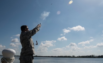 U.S. Air Force Staff Sgt. Curtis March, 628th Security Forces Squadron patrolman, shoots off a pencil flare during a Shore Installation Management Basic Boat Coxswain Course Sept. 26, 2018, at Joint Base Charleston’s Naval Weapons Station, S.C. The SIMBBCC curriculum arms security forces members with skills needed to conduct harbor patrol missions and covers techniques including man overboard drills, pier approaches, towing and anchoring.
