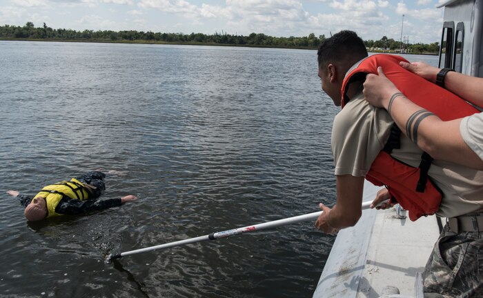 U.S. Air Force Senior Airman Marco Deleon, 628th Security Forces Squadron patrolman, participates in a man overboard drill during a Shore Installation Management Basic Boat Coxswain Course Sept. 26, 2018, at Joint Base Charleston’s Naval Weapons Station, S.C. The SIMBBCC curriculum arms security forces members with skills needed to conduct harbor patrol missions and covers techniques including man overboard drills, pier approaches, towing and anchoring.