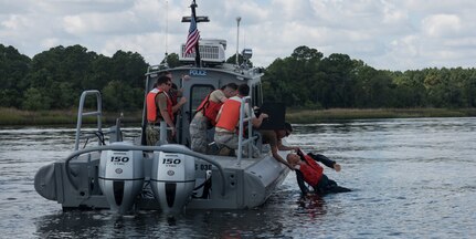 Sailors and Airmen participate in man overboard drills during a Shore Installation Management Basic Boat Coxswain Course Sept. 26, 2018, at Joint Base Charleston’s Naval Weapons Station, S.C. The SIMBBCC curriculum arms security forces members with skills needed to conduct harbor patrol missions and covers techniques including man overboard drills, pier approaches, towing and anchoring.