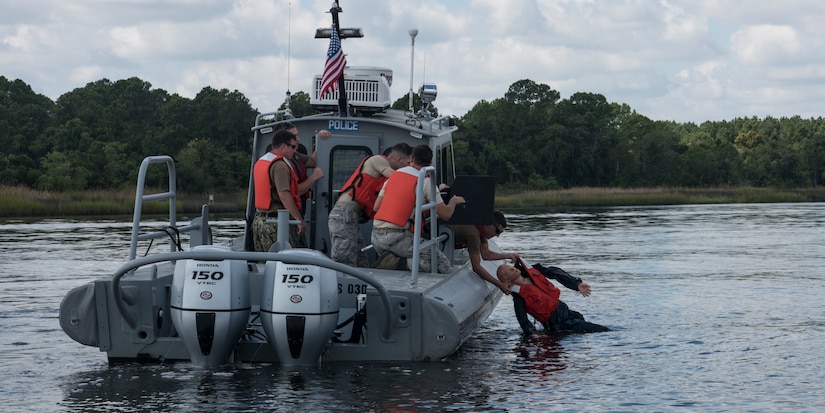 Sailors and Airmen participate in man overboard drills during a Shore Installation Management Basic Boat Coxswain Course Sept. 26, 2018, at Joint Base Charleston’s Naval Weapons Station, S.C. The SIMBBCC curriculum arms security forces members with skills needed to conduct harbor patrol missions and covers techniques including man overboard drills, pier approaches, towing and anchoring.