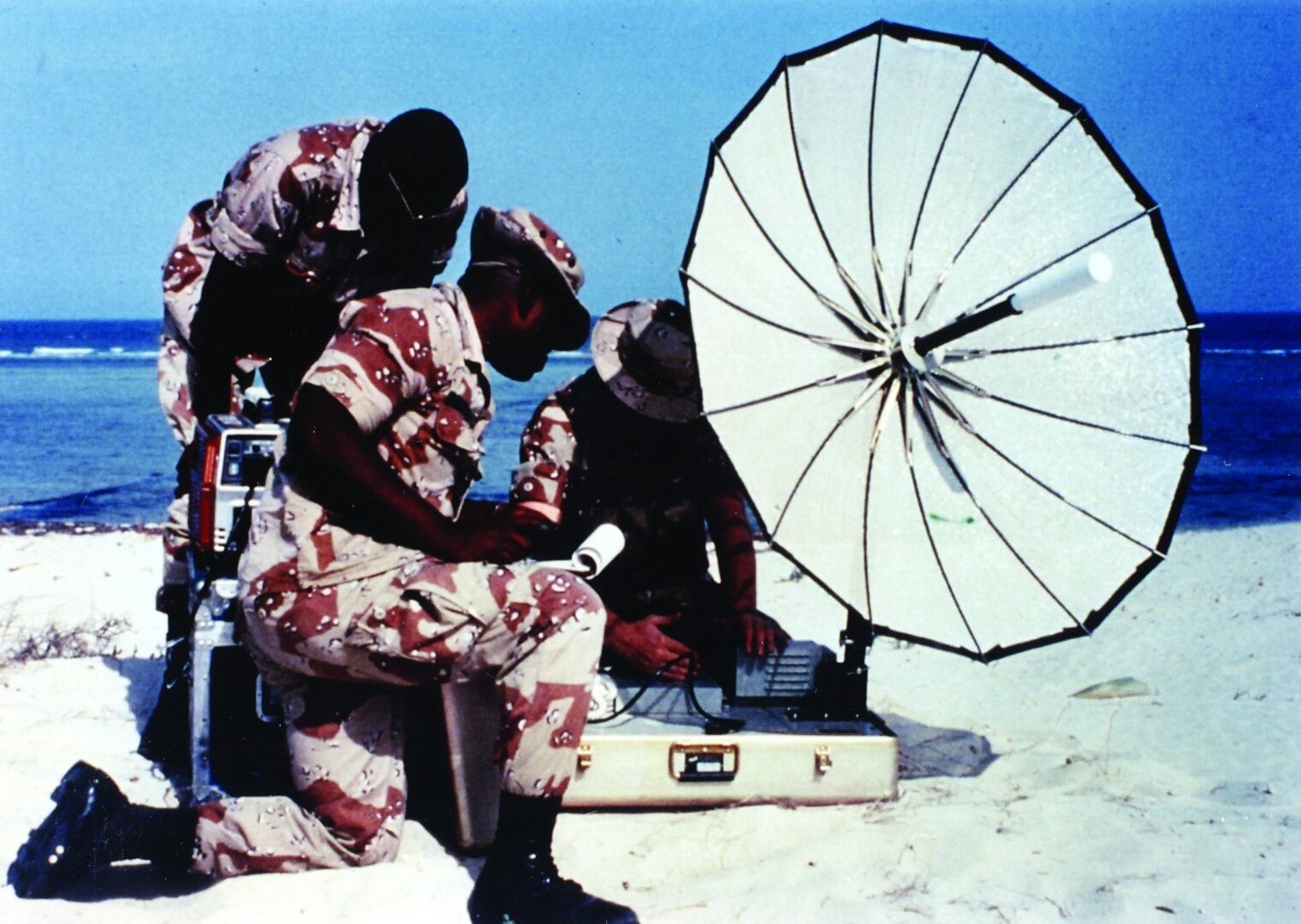 Airmen set up a mobile satellite communications system at Eskan Village, Saudi Arabia, in the early 1990s.