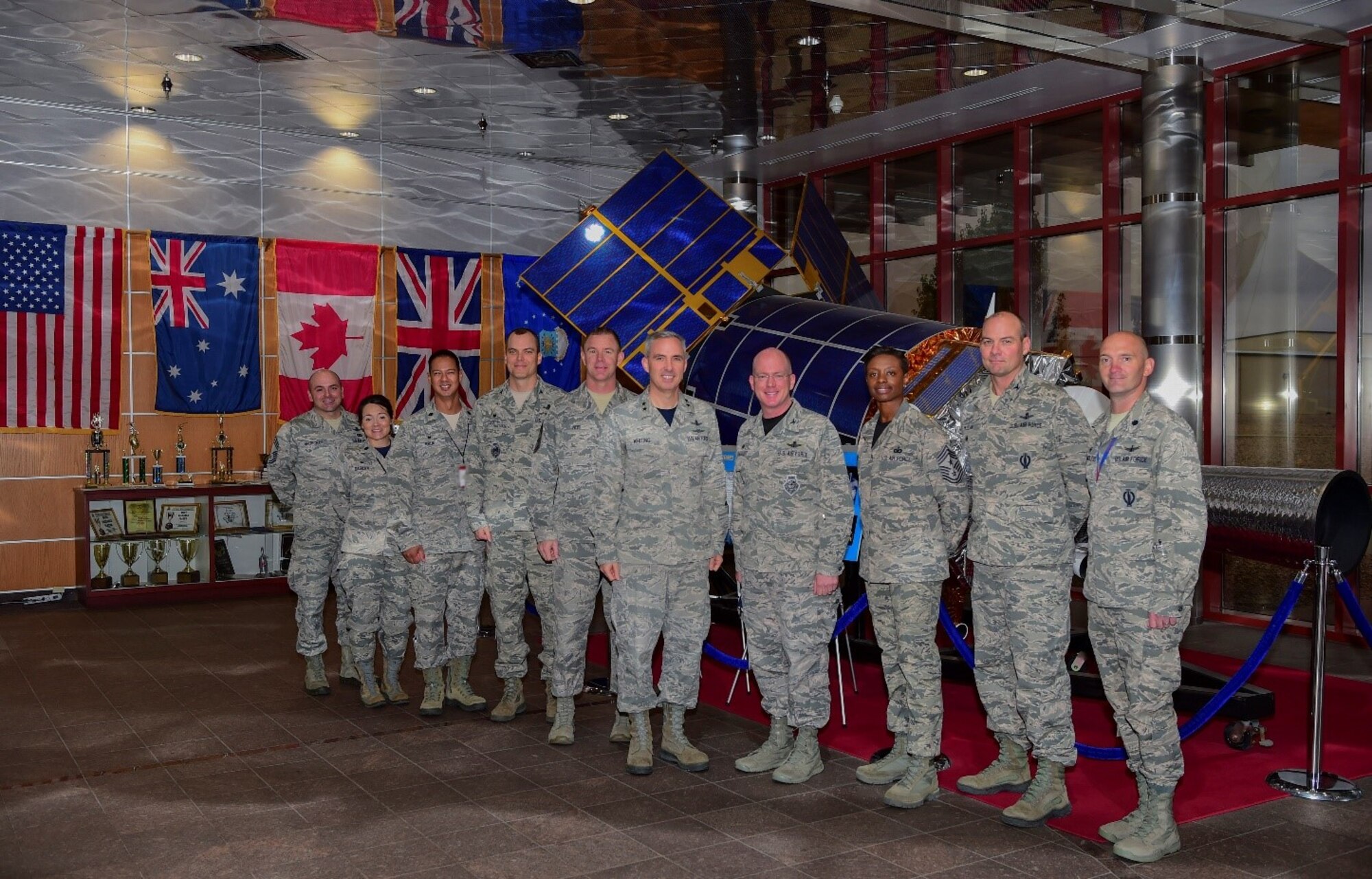 Maj. Gen. Stephen Whiting, 14th Air Force commander, Air Force Space Command, and Chief Master Sgt. Craig Neri, 14th Air Force command chief, stand with Team Buckley leadership in the 460th Operations Group Mission Control Station during their visit Sept. 28, 2018, on Buckley Air Force Base, Colorado. Whiting leads almost 16,000 members responsible for providing strategic missile warning, nuclear command, control and communication, position, navigation and timing, space situational awareness, satellite operations, space launch and range operations. (U.S. Air Force photo by Airman 1st Class Holden S. Faul)