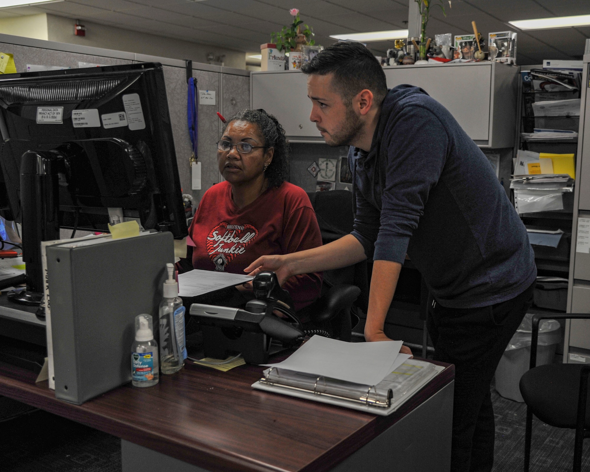 Budget Analysts Nicki Valverde-Maxey (left) and Juvenal Castillo, 377th Comptroller Squadron, ensure fiscal year closeout work is reconciled minutes after midnight Oct. 1, 2018. (U.S. Air Force photo by Jim Fisher)