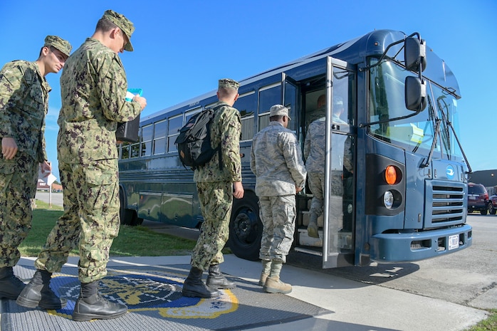 Airmen and Sailors board a bus at the Passenger Terminal Oct. 2, 2018, at Joint Base Charleston, S.C. The service members were preparing for an incentive flight, which they earned by distinguishing themselves within their respective units. Leadership from the 628th Air Base Wing and the 437th Airlift Wing collaborated to provide flying opportunities for non-aircrew service members.