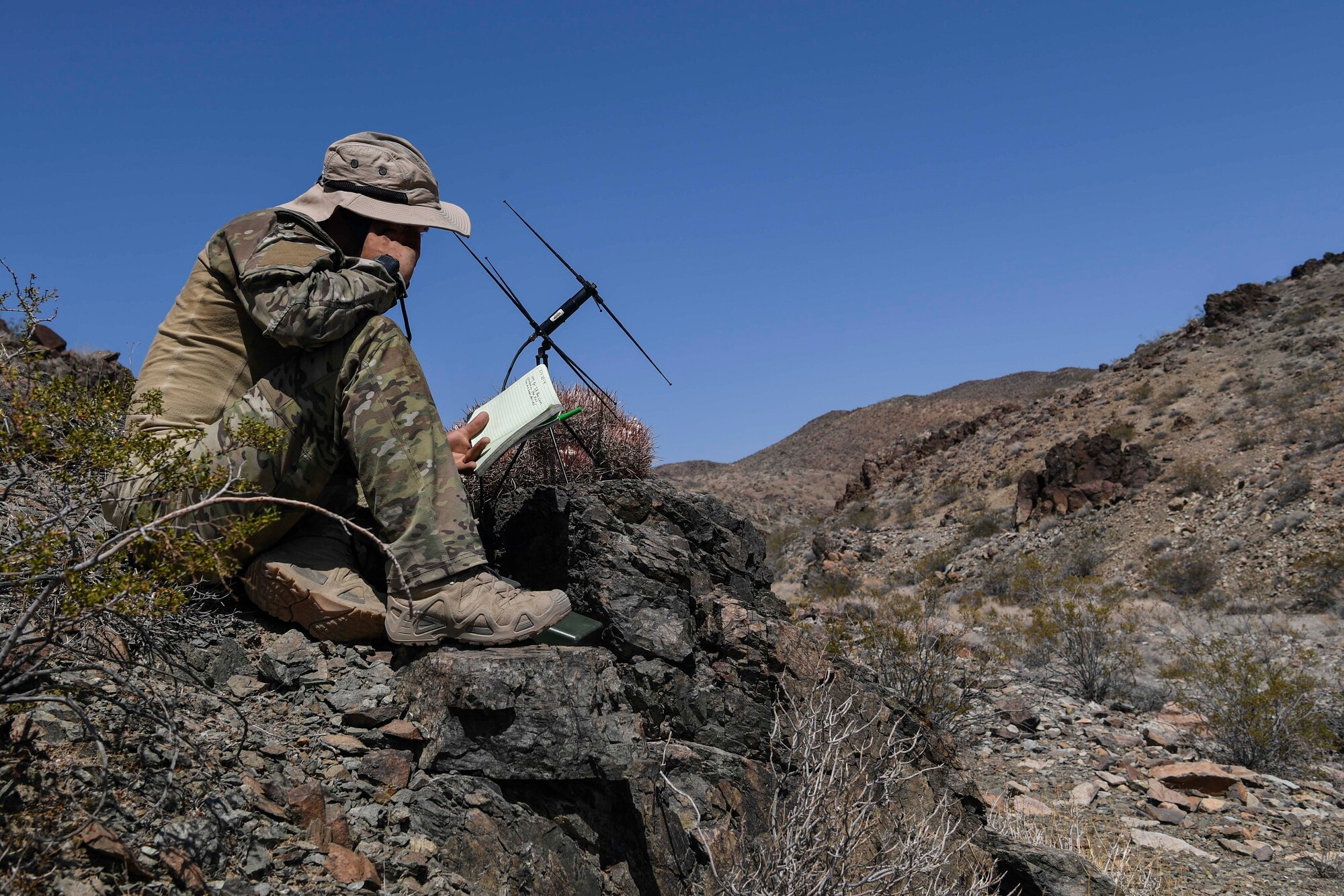 A Special Tactics Airman from the 21st Special Tactics Squadron from Pope Army Airfield, Fort Bragg, North Carolina, uses a satellite communication antenna to coordinate precision fires with his joint team during a scenario as part of NTC 18-10 at Fort Irwin, California, Sept. 2, 2018.