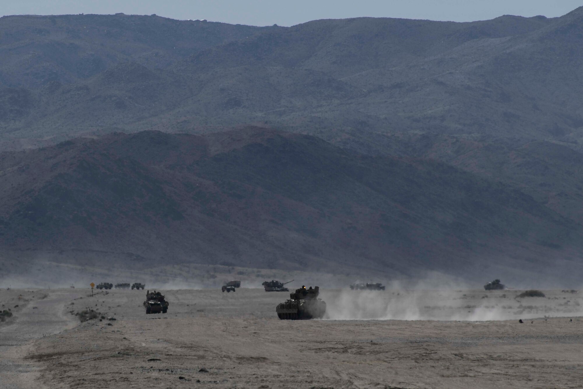 Conventional forces with the 1st Brigade Combat Team, 10th Mountain Division from Fort Drum, New York, and the 520th Infantry Battalion from Joint Base Lewis-McChord, Washington, conduct battlefield training against an opposing force during a scenario as part of National Training Center 18-10 at Fort Irwin, California, Sept. 2, 2018.
