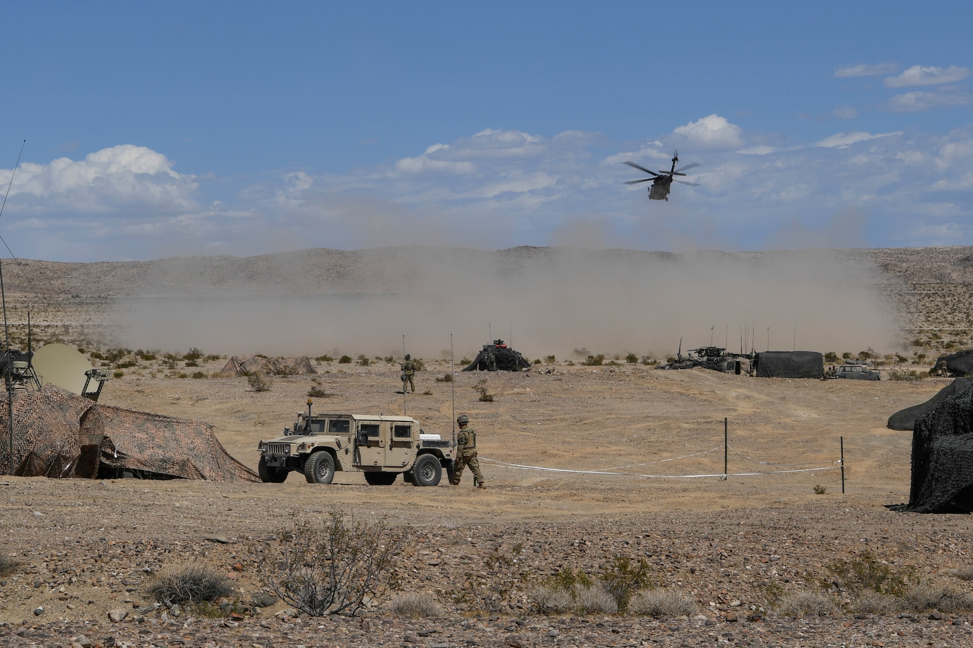 An Army AH-64 Apache helicopter lands as it brings leaders of the 520th Infantry Battalion based out of Joint Base Lewis-McChord, Washington, to a planning meeting for a simulated operation during a scenario as part of NTC 18-10 at Fort Irwin, California, Sept. 5, 2018.