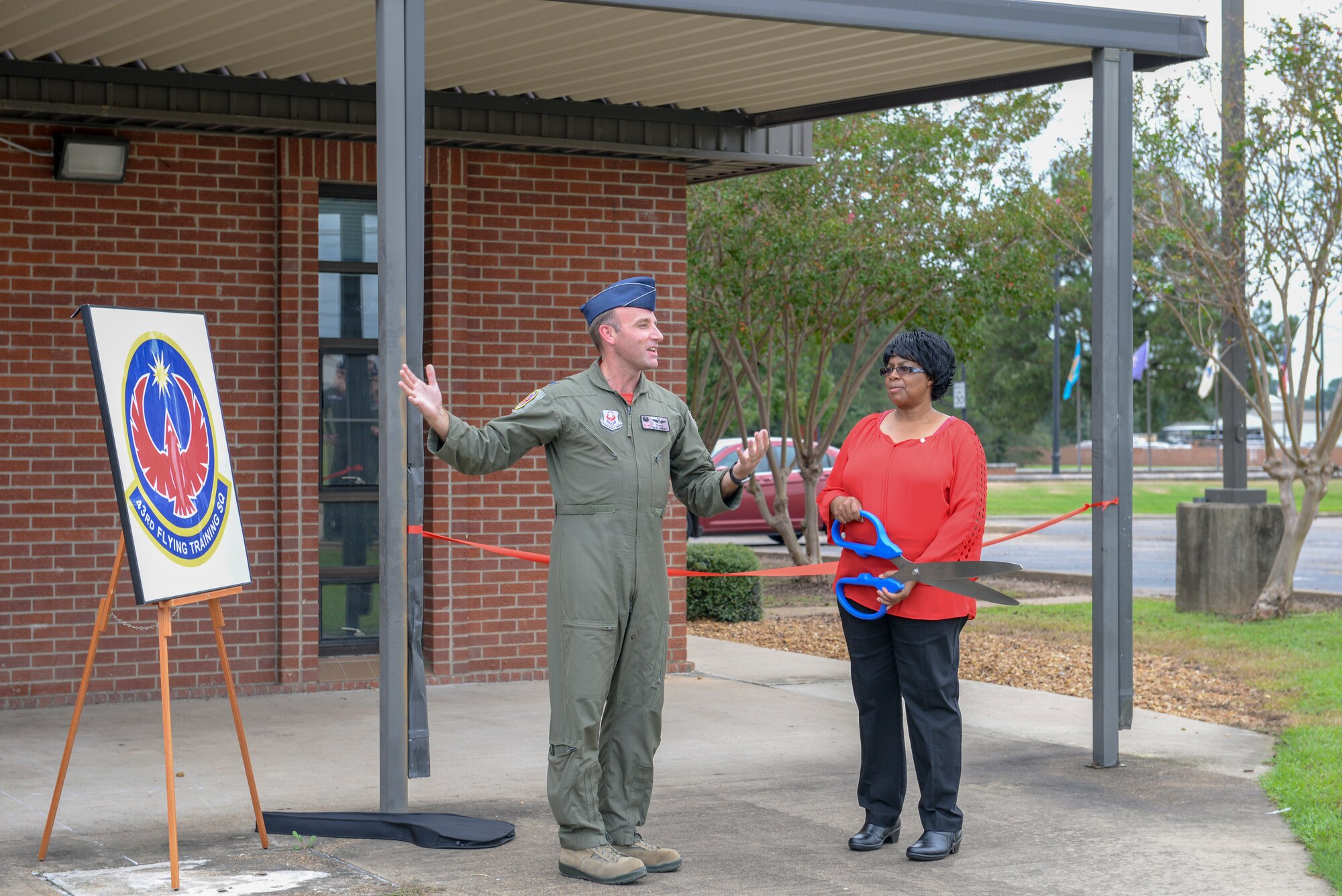 Lt. Col. Tom McElhinney, 43rd Flying Training Squadron commander, and Elaine Hobson, former 43rd Flying Training Squadron secretary welcomes attendees during the dedication ceremony for the squadron’s new building Sept. 28, 2018, on Columbus Air Force Base, Mississippi. Hobson recently retired after 17 years of civil service.  (U.S. Air Force photo by Airman Hannah Bean)