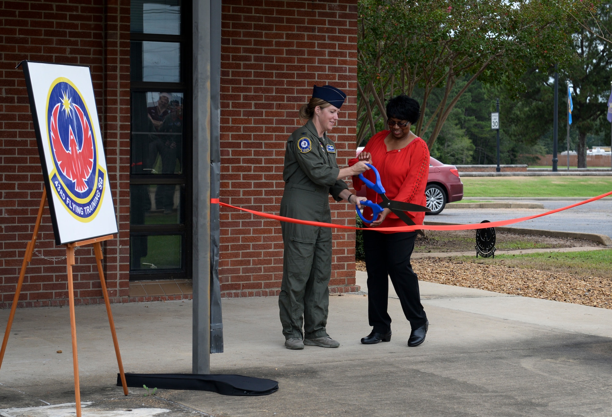 Col. Samantha Weeks, 14th Flying Training Wing commander, and Elaine Hobson, former 43rd Flying Training Squadron secretary, cuts the ribbon at the dedication ceremony Sept. 28, 2018, on Columbus Air Force Base, Mississippi. The 43rd FTS is one of several units at Columbus AFB that aids in creating pilots.  (U.S. Air Force photo by Airman Hannah Bean)