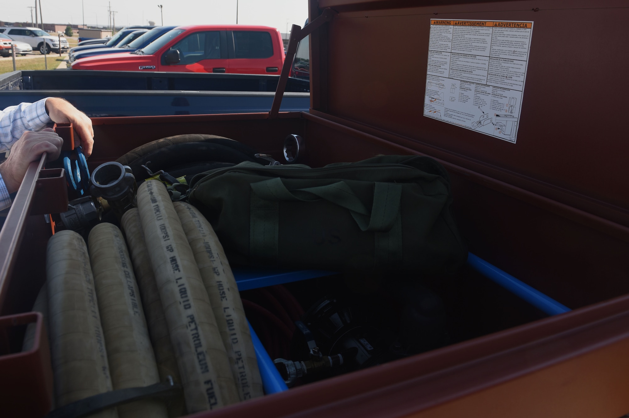 Kevin Goyer, a 28th Civil Engineer Squadron water quality program engineer, displays the inside of the Jobox on the SpillRaider trailer outside of the 28th CES headquarters at Ellsworth Air Force Base, S.D., Sept. 17, 2018. Goyer, and members of the 28th Maintenance Group, converted old oil trailers into a flight line spill trailer to make fuel spill cleanup faster, safer and more efficient. (U.S. Air Force photo by Airman Christina Bennett)