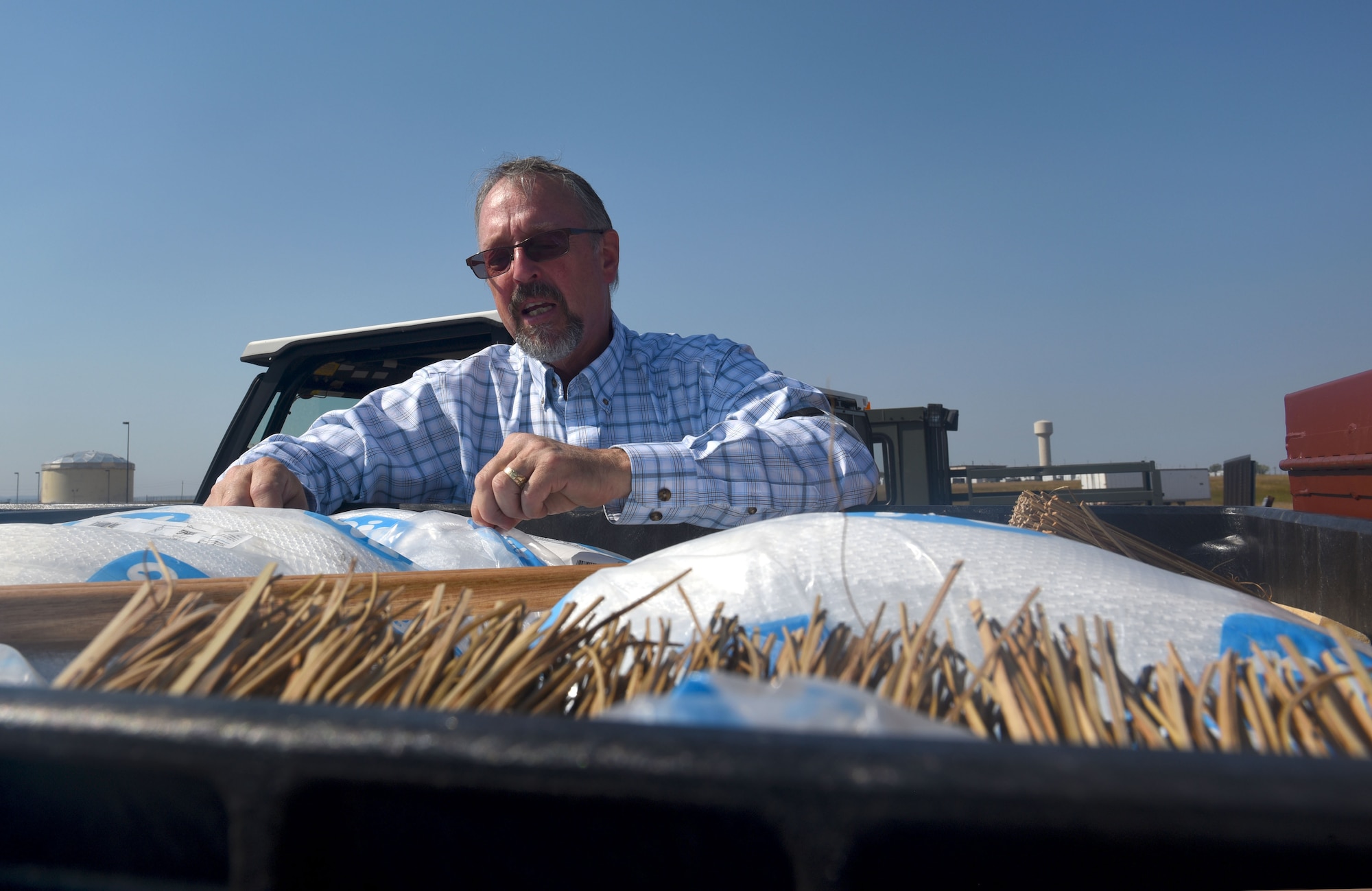 Kevin Goyer, a 28th Civil Engineer Squadron water quality program engineer, displays items that are included in the SpillRaider trailer at Ellsworth Air Force Base, S.D., Sept. 17, 2018. Goyer and members of the 28th Maintenance Group, converted old oil trailers into a flight line spill trailer to make fuel spill cleanup faster, safer and more efficient. (U.S. Air Force photo by Airman Christina Bennett)