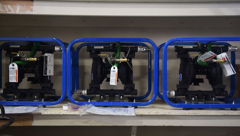 Three air-operated, fuel-rated pumps are prepared to be inserted into the Jobox of the SpillRaider trailer at a warehouse facility on Ellsworth Air Force Base, S.D., Sept. 17, 2018. The SpillRaider is a trailer designed to make fuel spill cleanup equipment and personal protective equipment readily available to maintenance Airmen on the flight line. (U.S. Air Force photo by Airman Christina Bennett)