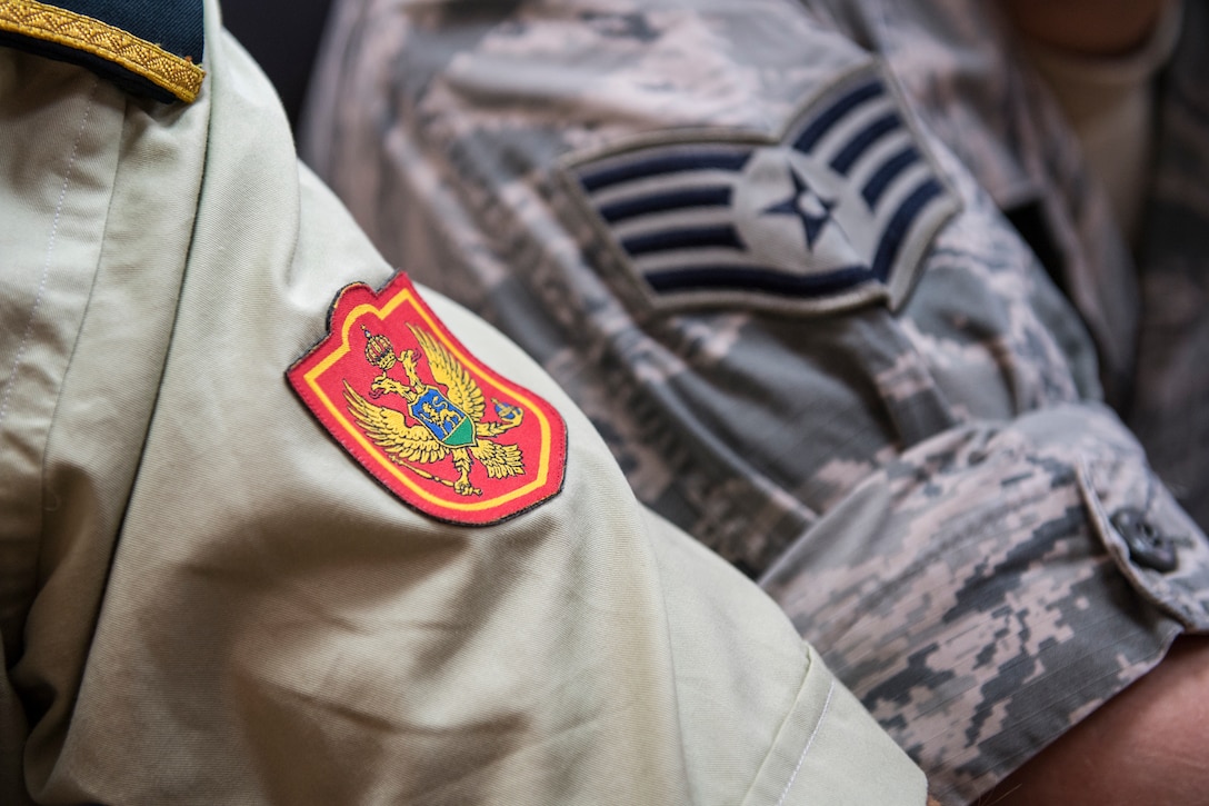 A member of the Ministry of Defense of Montenegro and a U.S. Cyber Command Airman, pose for a photo during Defensive Cooperation at Podgorica, Montenegro, Sept. 28, 2018. The U.S. and NATO Allies and partners are working together to provide agile forces to respond to 21st century security challenges – including cyber, hybrid and unconventional threats. Defensive Cyber cooperation is part of U.S. Cyber Command and U.S. European Command effort to support NATO allies and European partners by helping build their cyber defense capabilities. This collaboration builds cyber defense capabilities while enabling the teams to learn from one another and demonstrates that we will not tolerate foreign malign influence on the democratic processes of our allies and partners or in the U.S (U.S. Army photo by Spc. Craig Jensen)