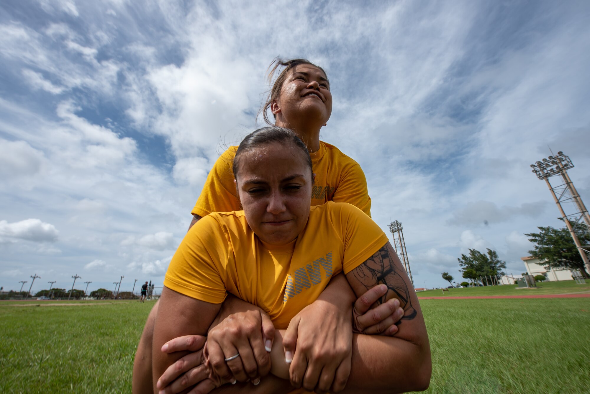 U.S. Navy Petty Officer 3rd Class Emily Pall carries Petty Officer 2nd Class Eva Aguilar, both Okinawa Joint Experience Green Team students, during the Okinawa Joint Fitness Challenge Sept. 26, 2018, at Kadena Air Base, Japan. The OJFC was designed to mimic obstacles and challenges faced in the battlefield such as sprinting, running ammunition cans, transporting wounded personnel to safety and tossing simulated grenades. Each team competed for the best time, however the final challenge brought all four teams together. (U.S. Air Force photo by Staff Sgt. Micaiah Anthony)