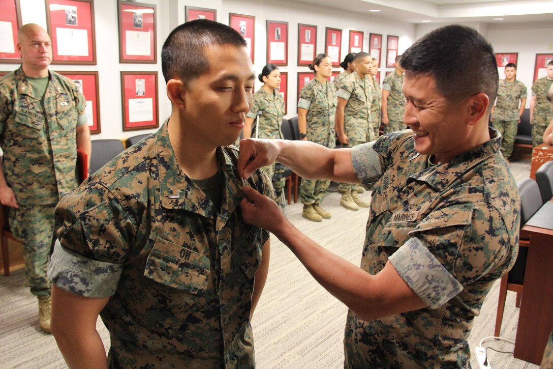 USAG CAMP HUMPHREYS, Republic of Korea – Capt. Grady Kurpasi (right), U.S. Marine Corps Forces Korea G37 assistant plans officer, pins 1st Lt. Seakun Oh, MARFORK G37 exercise officer, with the rank of captain during his frocking ceremony here, Oct. 1. Oh, a native of Queens, New York, frocked to captain due to the level of responsibility required and expectations of his billet within the combined joint community. (U.S. Marine Corps photo by Capt. John Parry/Released)