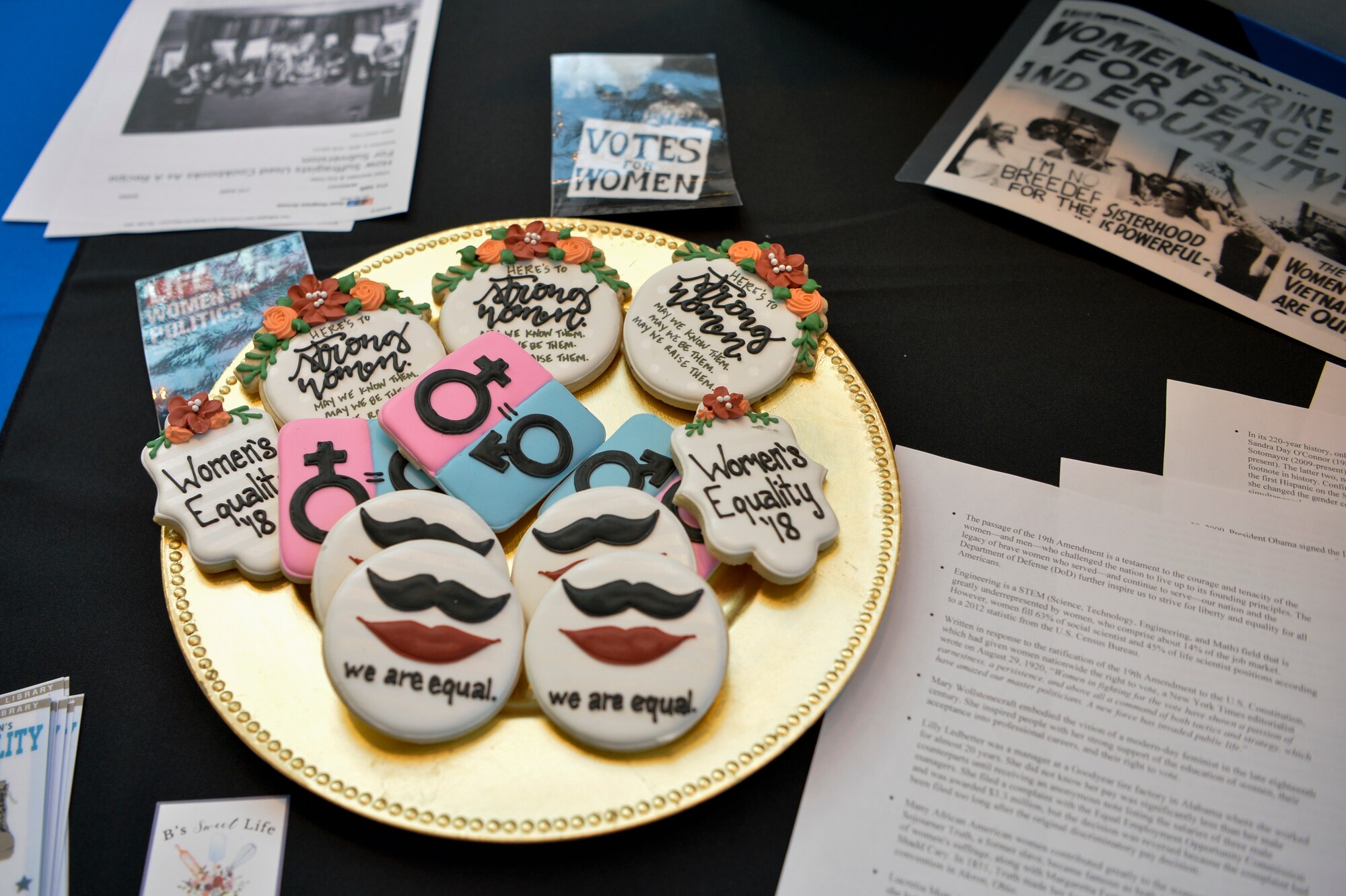 The Women’s History Month observance stand at the 86th Airlift Wing’s Diversity Day offered cookies as prizes to attendees participating in their trivia questions on Ramstein Air Base, Sept. 28, 2018. The event encompassed 10 annual observances with educational stands, cuisines and cultural performances. (U.S. Air Force photo by Staff Sgt. Nesha Humes Stanton)