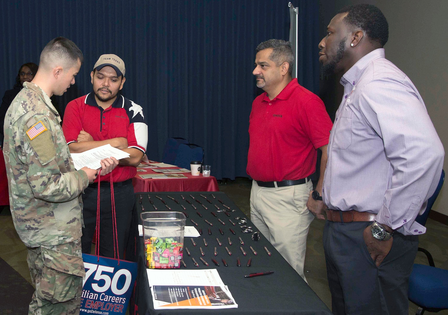 Employers meet with military members during the Hiring Heroes Career Fair at the Sam Houston Community Center at Joint Base San Antonio-Fort Sam Houston Sept. 19. More than 70 employers, from the private to the governmental sector, were present to showcase their employment opportunities, as well as scout America's best talent.