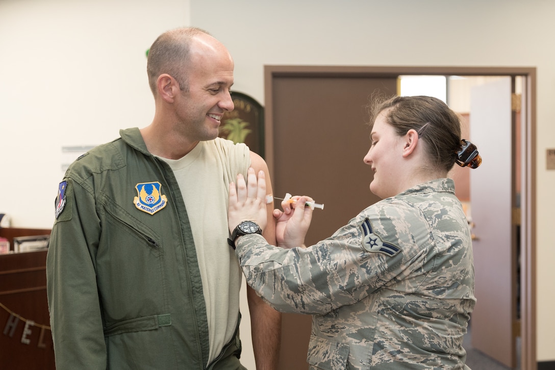 Brig. Gen. E. John Teichert, 412th Test Wing commander, receives his annual flu vaccination from Airman 1st Class Jessica Davidson, 412th Medical Operations Squadron, outside his office Sept. 26 (U.S. Air Force photo by Don Allen)