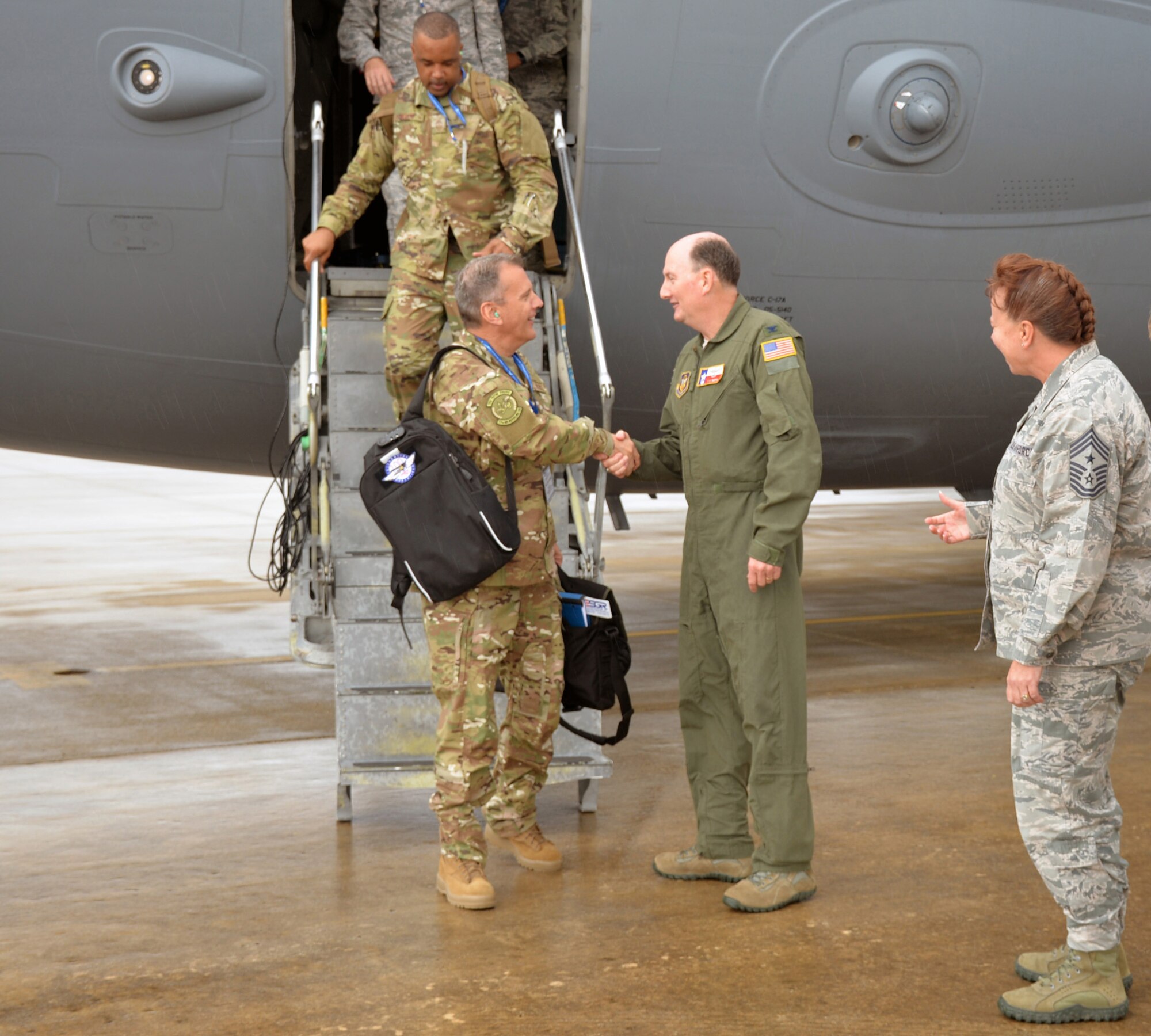 Maj. Gen. Randall A. Ogden, 4th Air Force commander, and 4th AF Command Chief Master Sgt. Timothy C. White Jr. deplane and are greeted by Col. Thomas K. Smith Jr., 433rd Airlift Wing commander, and 433rd AW Command Chief Master Sgt. Shana C. Cullum at Joint Base San Antonio-Lackland, Texas Oct. 1, 2018.
