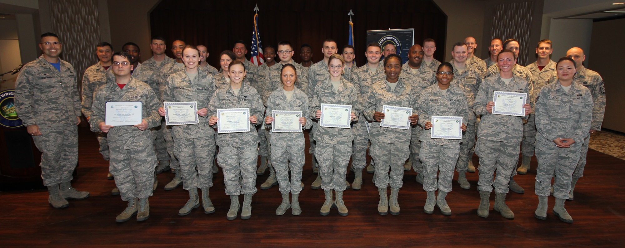 Col. Tom Sherman, 88th Air Base Wing and installation commander, (left), and Chief Master Sgt. Stephen Arbona, 88th Air Base Wing command chief (right), honored the newest Team Wright-Patt enlisted promotees during a ceremony at the Wright-Patt Club, Wright-Patterson Air Force Base, Ohio, Sept 28, 2018. (U.S. Air Force Photo/Thomas Lewis)