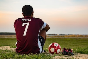 U.S. Air Force Airman 1st Class Jairzinho Burke, 633rd Air Base Wing Judge Advocate paralegal, sits at the soccer field during the intramural soccer season at Joint Base Langley-Eustis, Virginia. Burke started playing soccer at the age of 5 in Maypen, Jamaica.