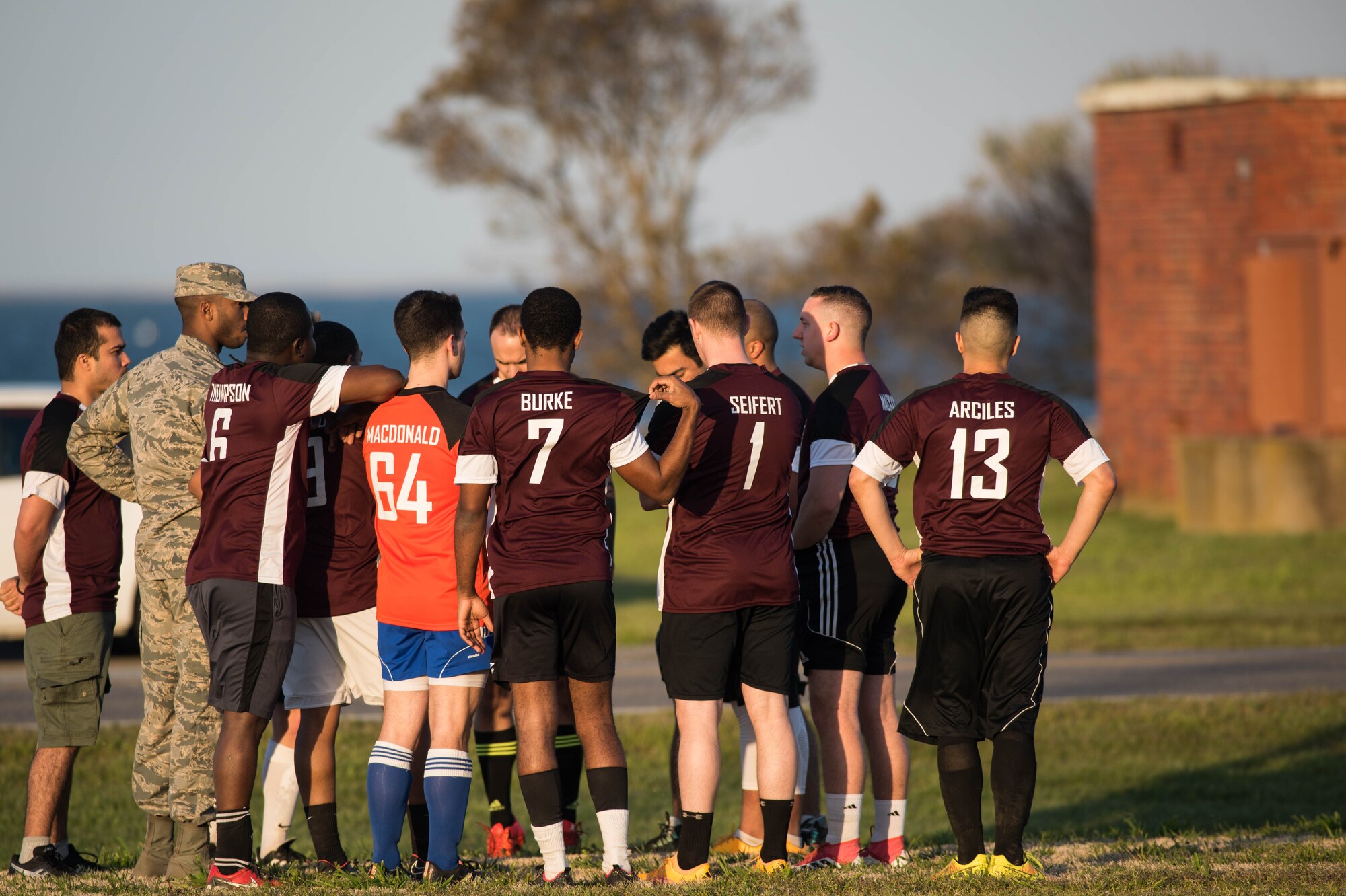 U.S. Air Force Airman 1st Class Jairzinho Burke, 633rd Air Base Wing Judge Advocate paralegal, huddles with teammates during an intramural soccer game at Joint Base Langley-Eustis, Virginia, April 12, 2018.