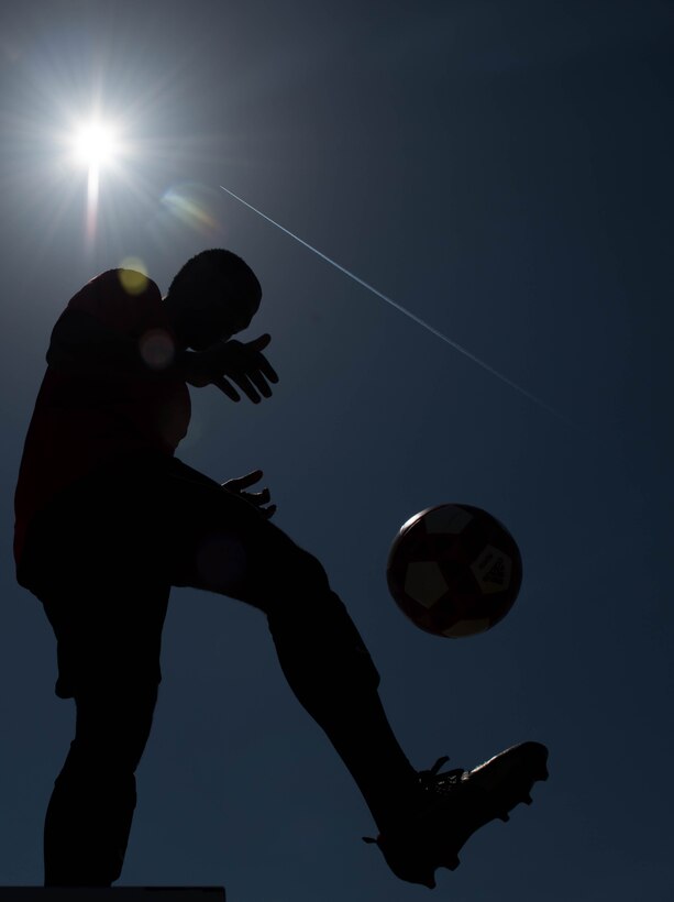 U.S. Air Force Airman 1st Class Jairzinho Burke, 633rd Air Base Wing Judge Advocate paralegal, practices his soccer skills at Joint Base Langley-Eustis, Virginia, April 13, 2018.