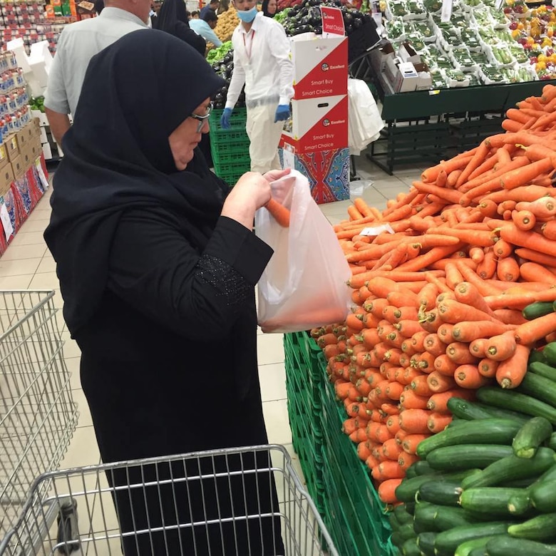 Becky Moser during a grocery shopping trip to the local Super Panda in Saudi Arabia. She cooks dinner for the team several times during her visits. “When shopping for vegetables you gather them up and have to go to a kiosk to have them weighed and tagged,” she said. “There is no actual line. You just have to sort of jockey for position. Where we have deli counters, in Saudi Arabia they have olive counters, offering every imaginable color and size.”