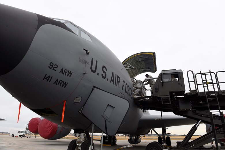 Airmen from the 92nd Logistics Readiness Squadron load cargo onto a KC-135 Stratotanker at Fairchild Air Force Base, Washington, September 2018. Mobility Airmen fuel the fight, provide airlift needed for supplies and personnel, and enable versatile and timely effects through contingency response ensuring mission success. (U.S. Air Force photo illustration/ Airman 1st Class Lawrence Sena)