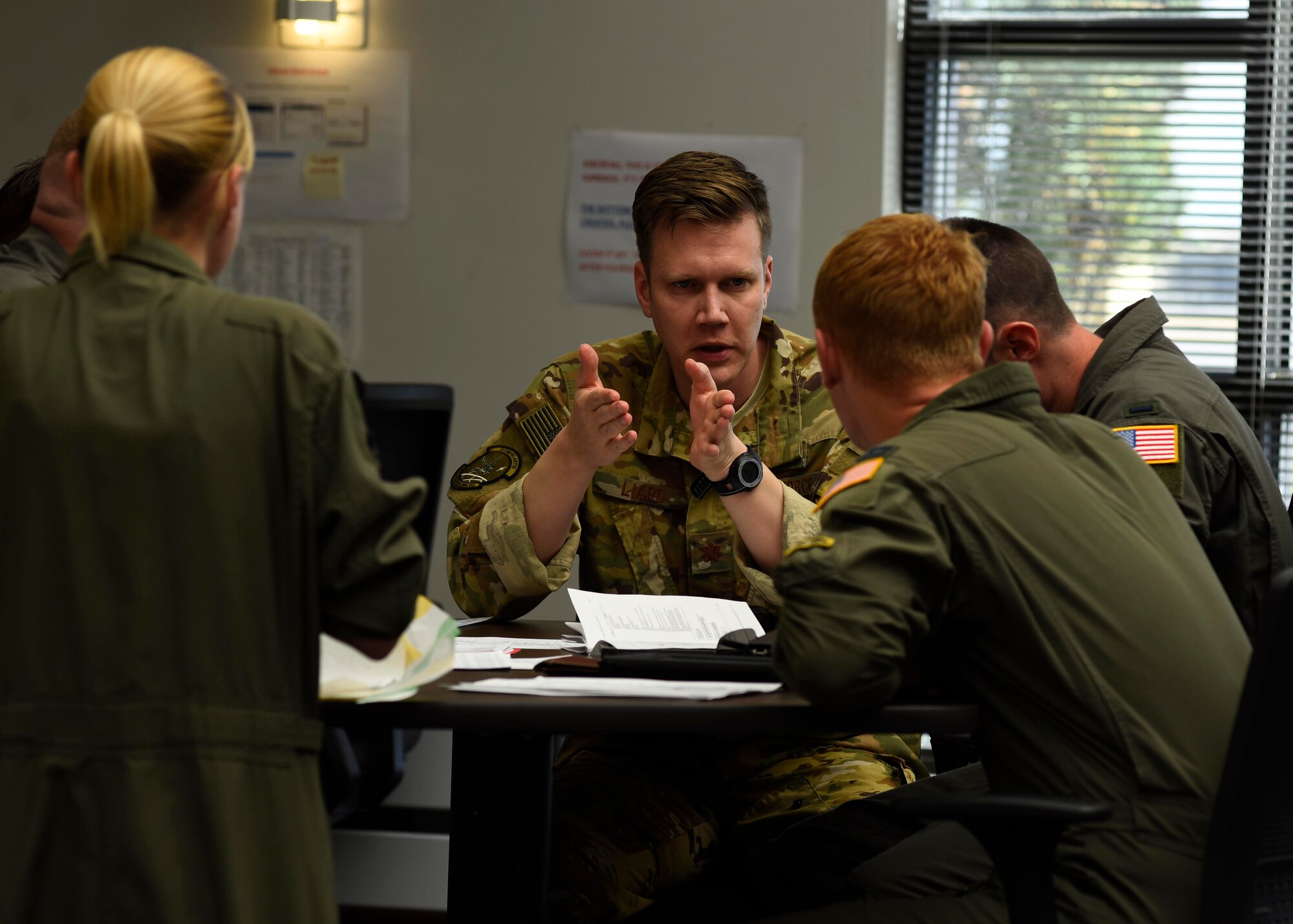 U.S. Air Force Maj. Jonathan Liard, Detachment Commander, briefs members of his team prior to boarding a KC-135 Stratotanker at Fairchild Air Force Base, Washington, September 2018. Mobility Airmen fuel the fight, provide airlift needed for supplies and personnel, and enable versatile and timely effects through contingency response ensuring mission success. (U.S. Air Force photo/Airman 1st Class Lawrence Sena)