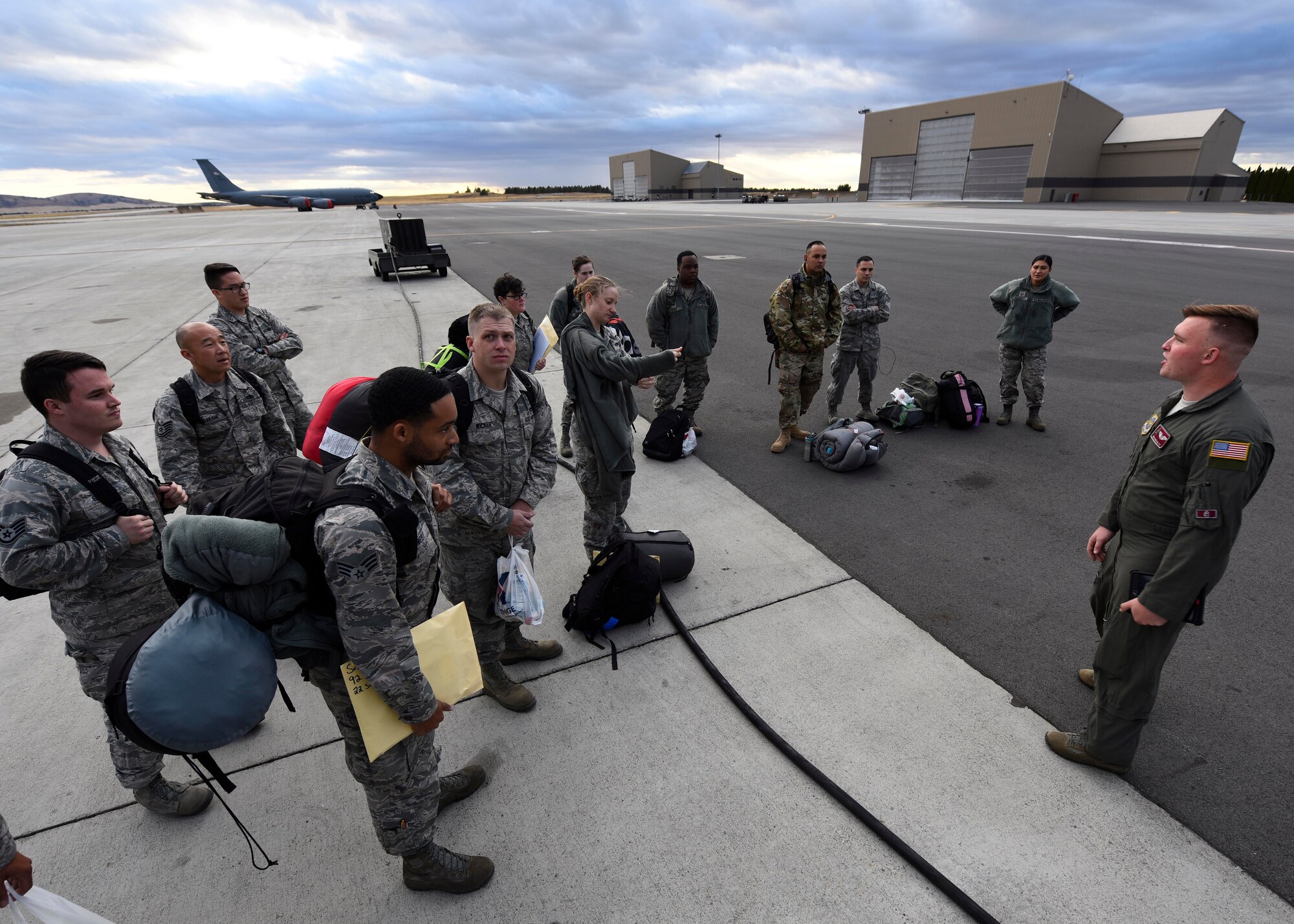 Senior Airman Daniel Daley, 384th Air Refueling Squadron in-flight refueling specialist, briefs service members prior to boarding a KC-135 Stratotanker at Fairchild Air Force Base, Washington, September 2018. Mobility Airmen fuel the fight, provide airlift needed for supplies and personnel, and enable versatile and timely effects through contingency response ensuring mission success. (U.S. Air Force photo/Airman 1st Class Lawrence Sena)