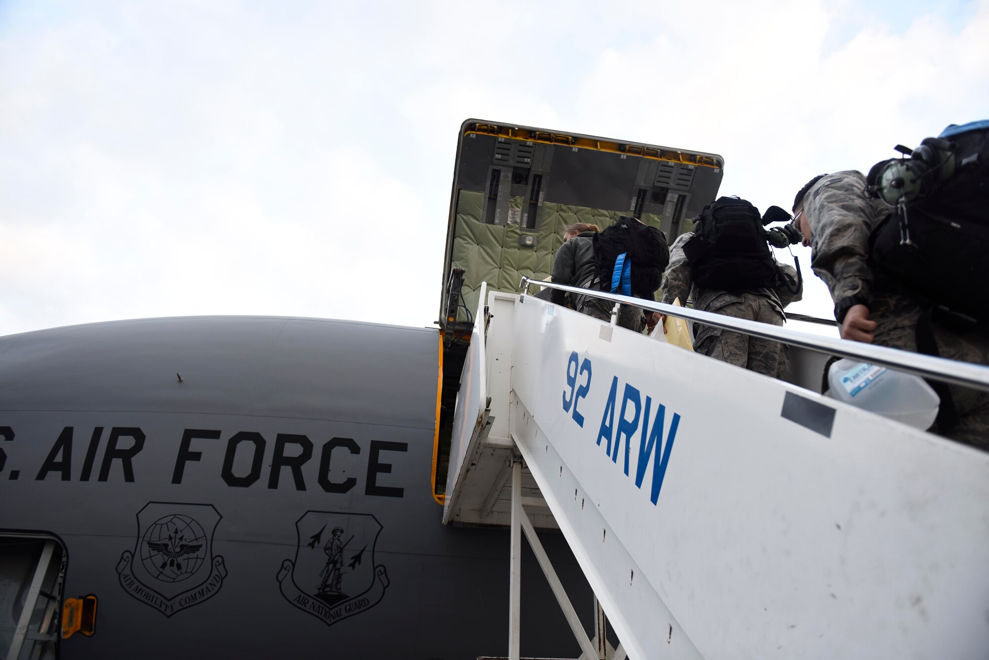 Service members from Fairchild board a KC-135 Stratotanker to depart in support of Operation Juniper Micron at Fairchild Air Force Base, Washington, September 2018. Fairchild's KC-135 Stratotankers have assist with allied operations worldwide, providing Global Reach to American and allied aircraft. (U.S. Air Force photo/Airman 1st Class Lawrence Sena)