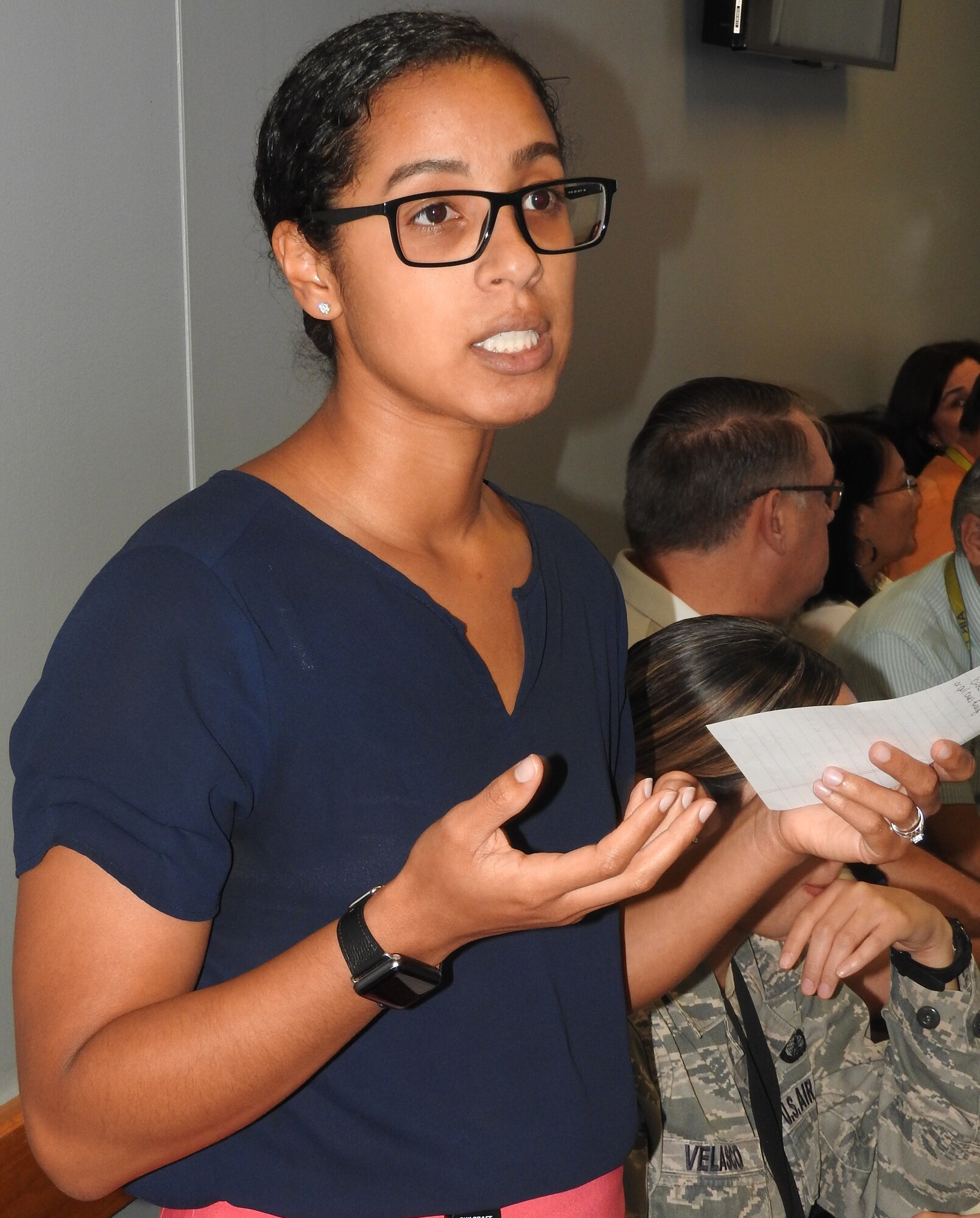 AFIMSC financial management specialist Jehan Abdulaziz updates war room members about Air Mobility Command installation status of funding, Sept. 19. (U.S. Air Force Photo by Ed Shannon)