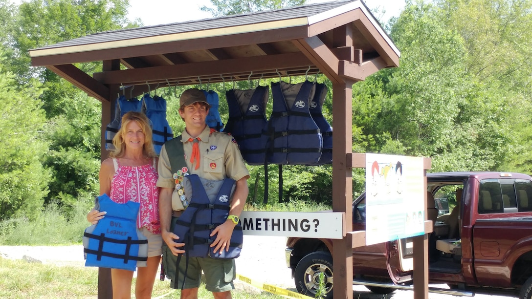 Matthew Mulcahy and his mother at the Life Jacket Loaner Kiosk he created for his Eagle Scout award.