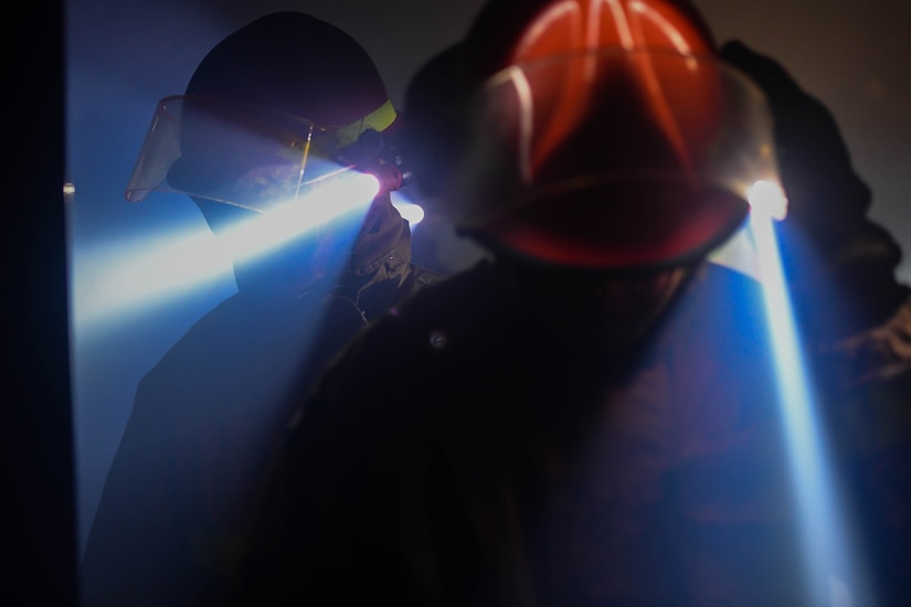 U.S. Army Soldiers navigate through a building using headlamps during a Fire and Ice Challenge at Joint Base Langley-Eustis, Virginia, Sept. 28, 2018. The fire simulator was filled with smoke, making it difficult to navigate the building to find the spot of the fire and the simulated casualty to rescue. (U.S. Air Force photo by Senior Airman Derek Seifert)