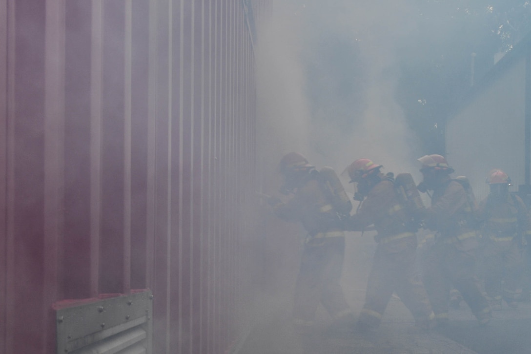 U.S. Army Soldiers walk into a fire simulator during a Fire and Ice Challenge at Joint Base Langley-Eustis, Virginia, Sept. 28. 2018. The teams were timed on how quickly they could extinguish a fire and save a simulated casualty. (U.S. Air Force photo by Senior Airman Derek Seifert)